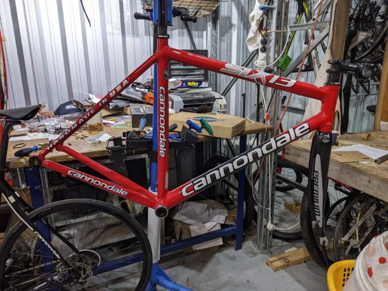 Cannondale Six13 roadbike on a Park Tool workstand in the workshop